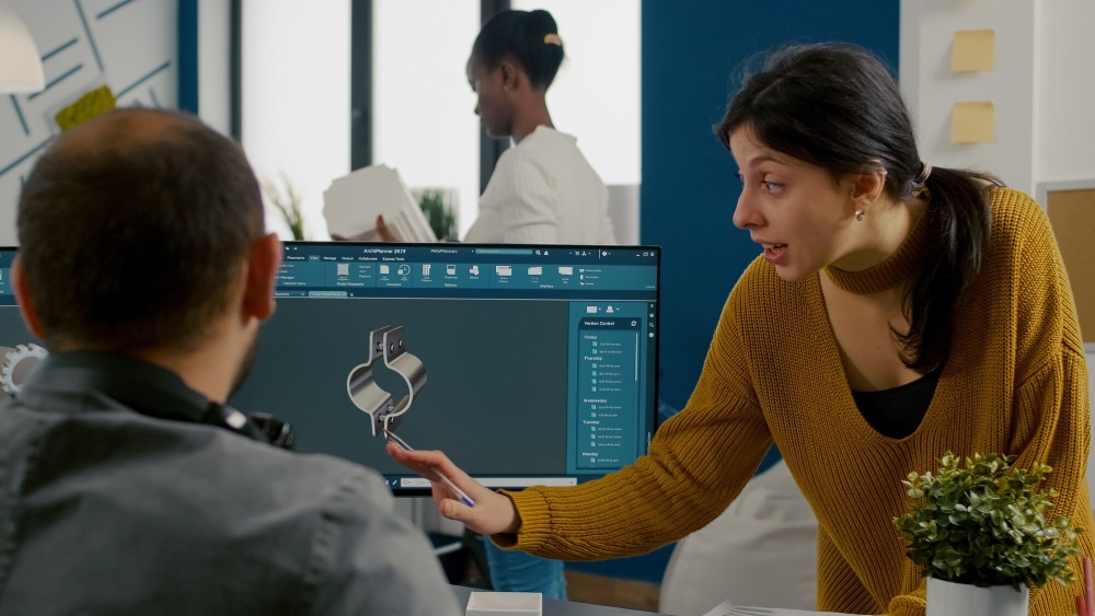 man and woman looking at the computer